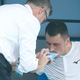 Bernard Tomic of Australia receives medical attention during his match against Denis Kudla of the U.S. during 2020 Australian Open Qualifying on January 14, 2020 in Melbourne, Australia.